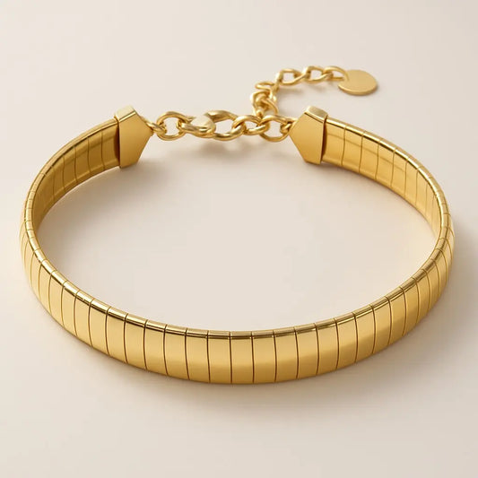 Gold bracelet on a light beige background