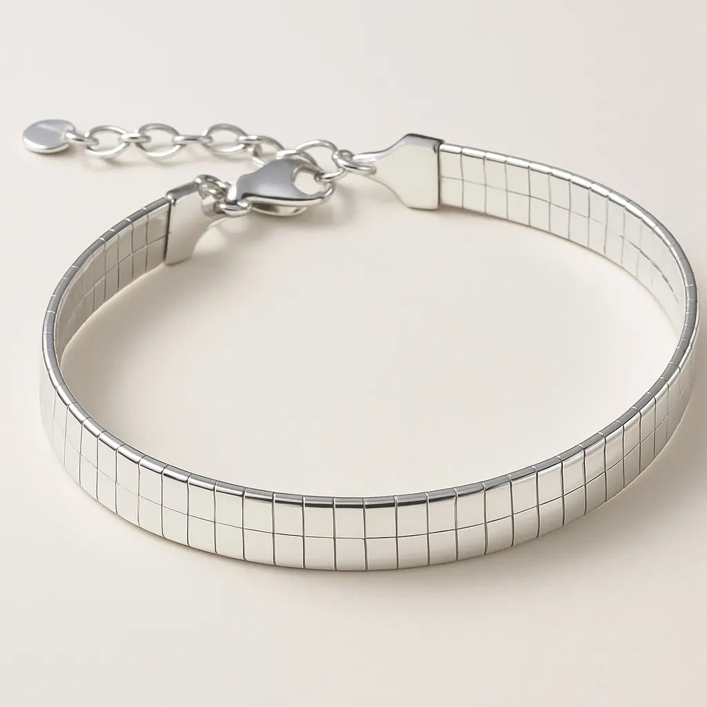 Silver bracelet with a checkered pattern on a light beige background