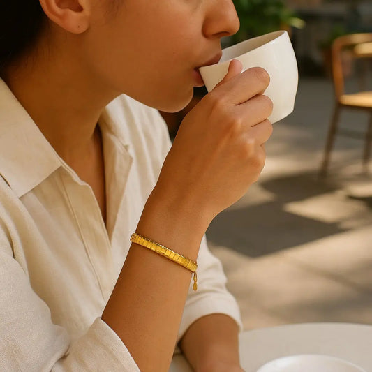 Person drinking from a white cup outdoors