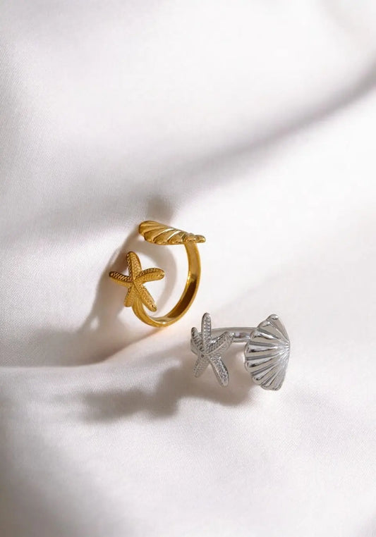 Gold and silver shell-shaped earrings on a white background