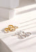 Gold and silver earrings on a light surface with soft shadows