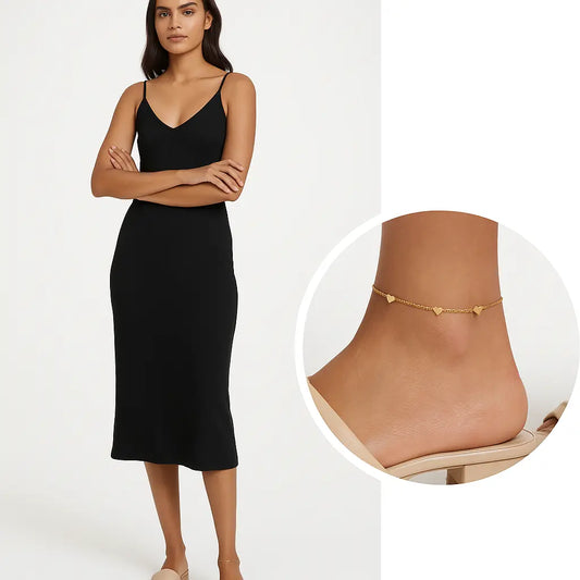 Woman wearing a black dress with an inset of a gold anklet on a white background