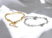 Gold and silver chain bracelets on a light background