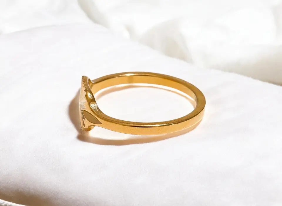 Gold ring on a white fabric background