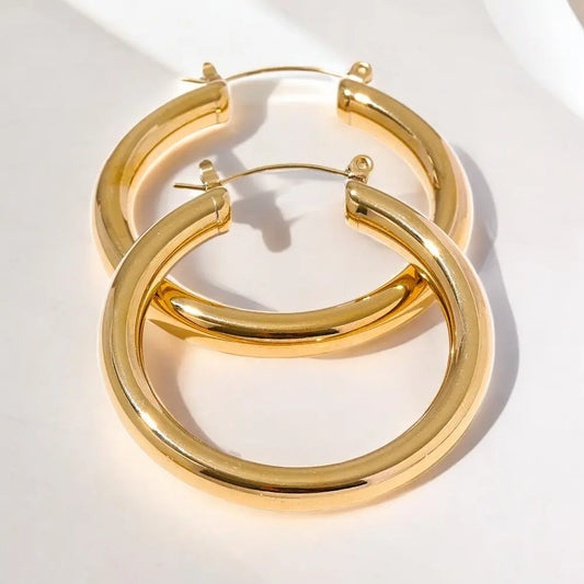 Gold hoop earrings on a white background