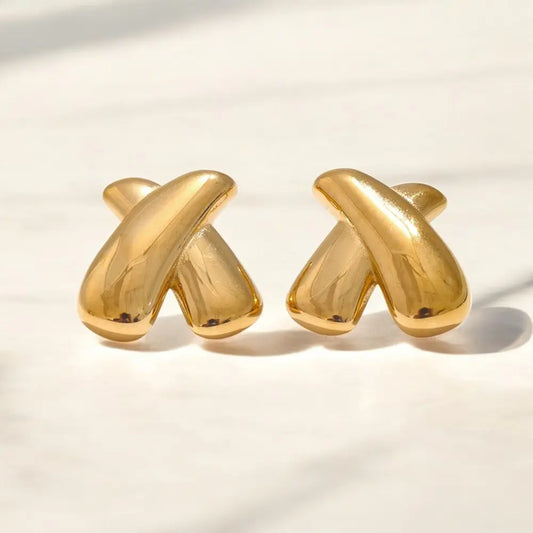 Pair of gold earrings on a light background