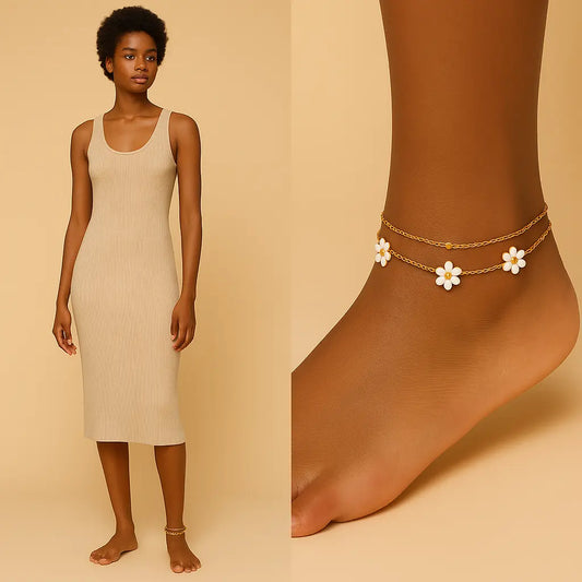 Woman wearing a beige dress with a close-up of her ankle wearing a floral anklet on a beige background