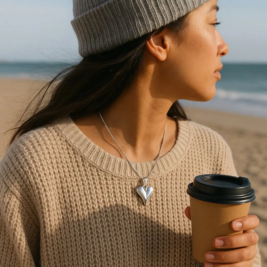 Woman holding a coffee cup on a beach