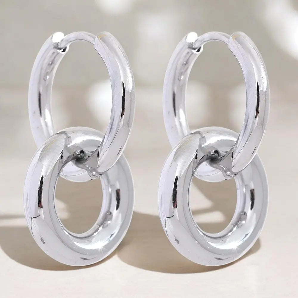 Pair of silver hoop earrings on a light background