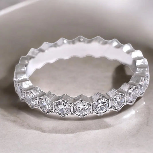 Silver ring with diamond stones on a white background