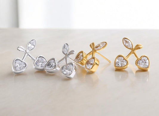 Pair of gold and silver earrings on a light background
