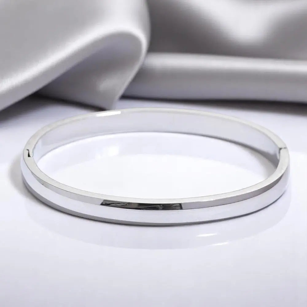 Silver bracelet on a light gray background
