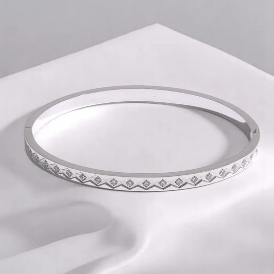 Silver ring with gemstone accents on a white surface