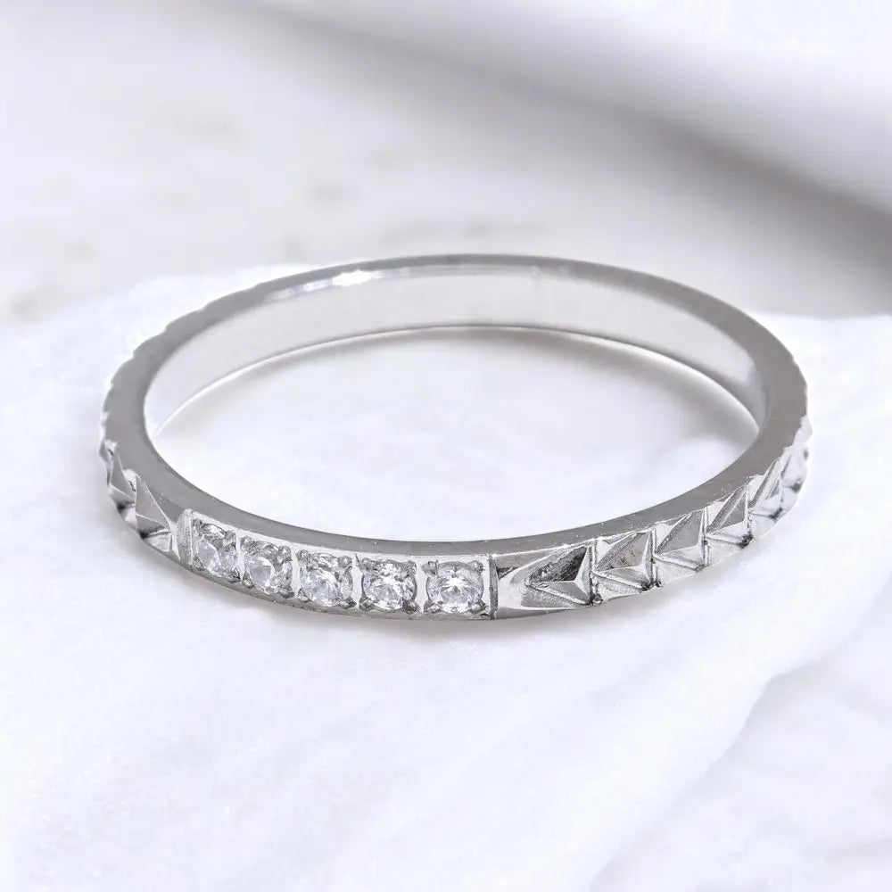 Silver ring with diamond stones on a white background