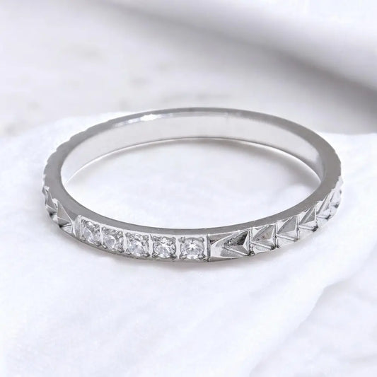 Silver ring with diamond stones on a white background