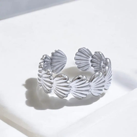 Silver shell-shaped bracelet on a white background