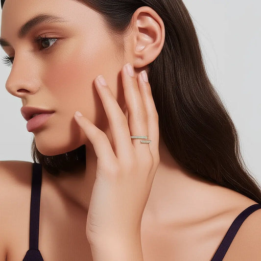 Woman wearing a silver ring on her hand against a neutral background