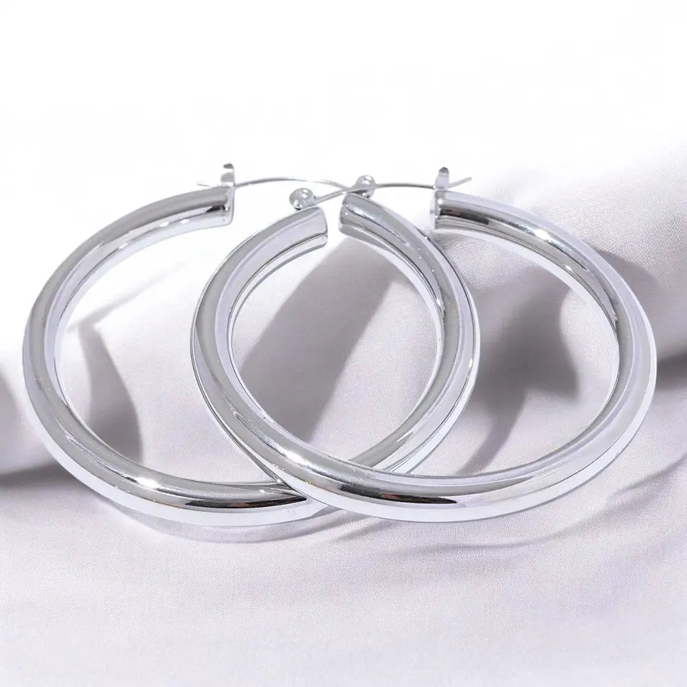 Pair of silver hoop earrings on a white background