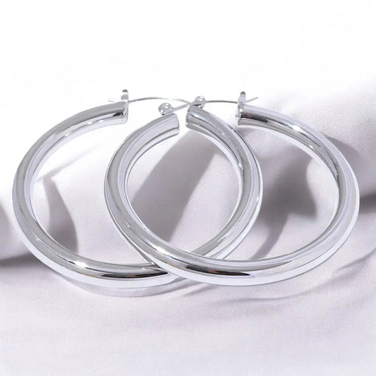 Pair of silver hoop earrings on a white background