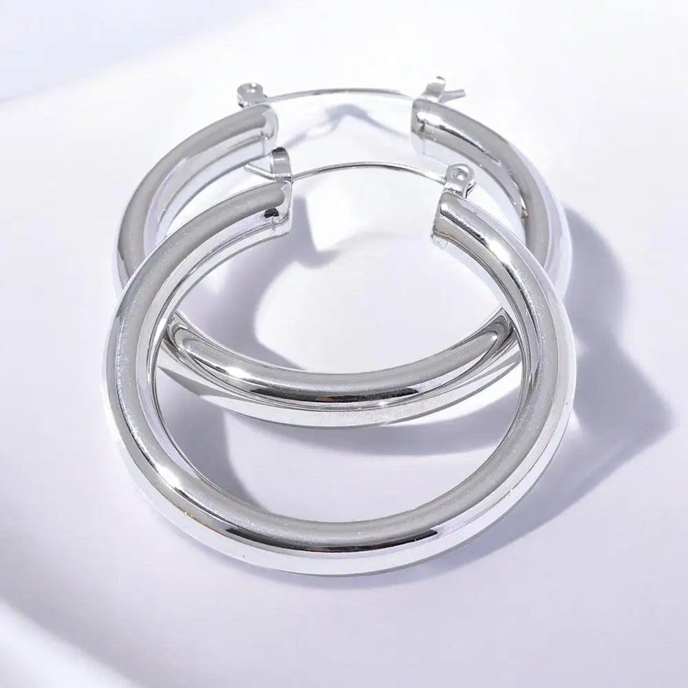 Silver hoop earrings on a light gray background