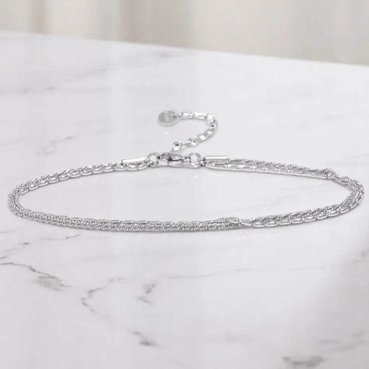 Silver chain bracelet on a marble surface