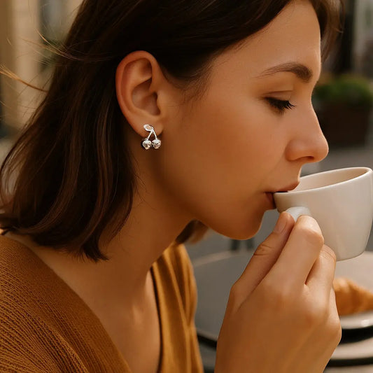 Woman drinking from a white cup with a blurred background