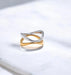 Two-toned gold and silver ring on a light gray background