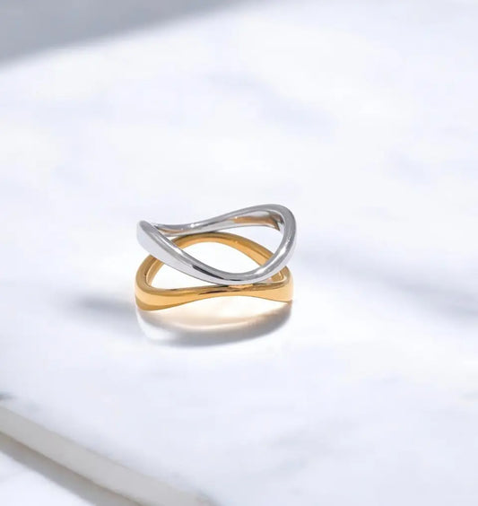 Two-toned gold and silver ring on a light gray background