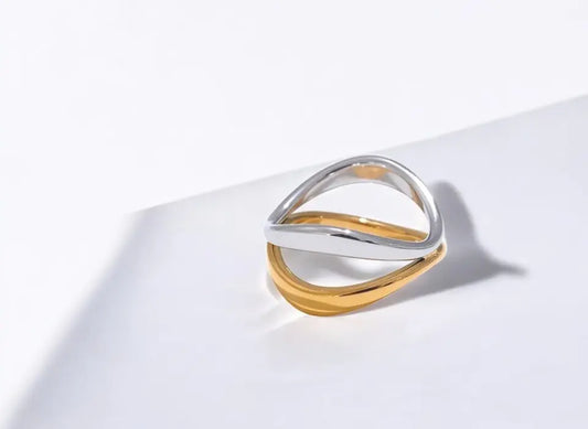 Gold and silver ring on a white surface