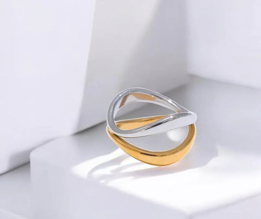 Gold and silver ring on a white surface