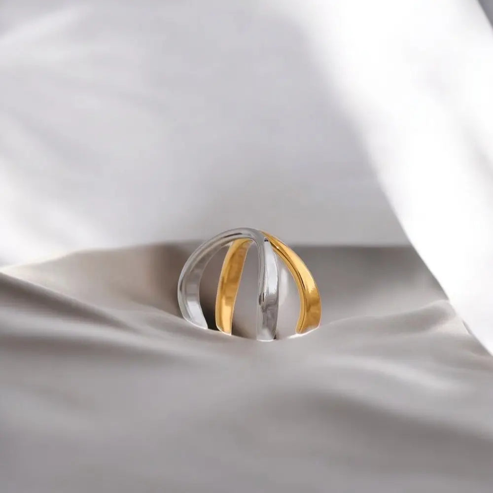 Two-toned ring on a white fabric background
