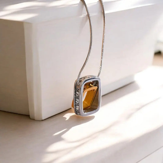 Necklace with a square pendant on a white surface